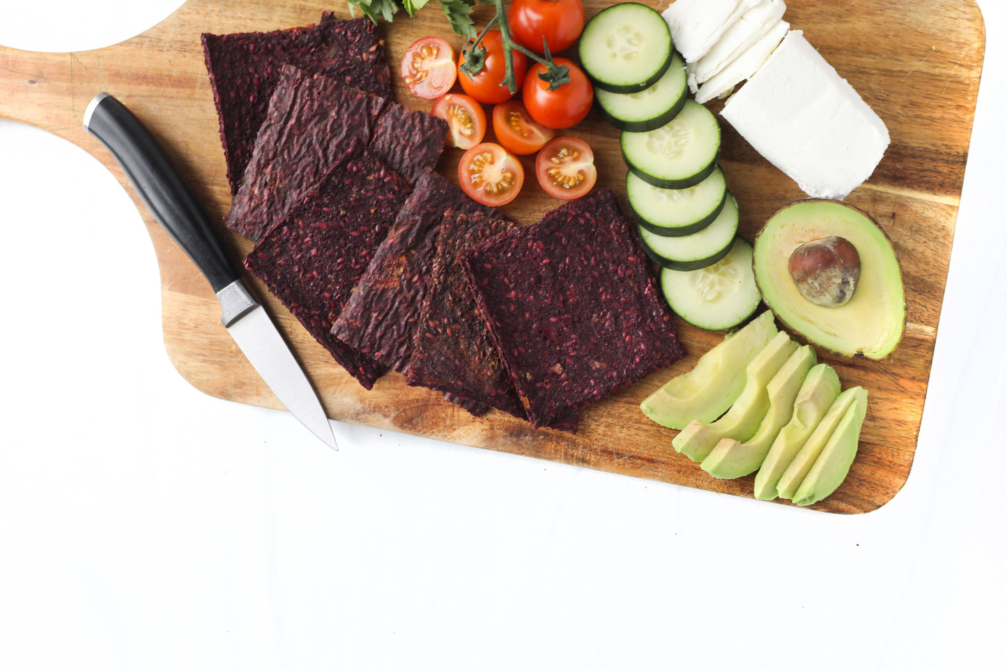 Kraut Krackers platter with avocado, cucumber, tomatoes, and cheese